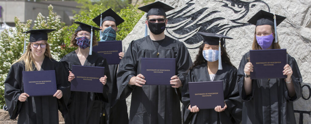 Photo of six proud Warhawks, the first cohort of the University of Wisconsin-Whitewater’s LIFE Program, who successfully completed their two-year program and crossed the stage in cap and gown in May 2021.