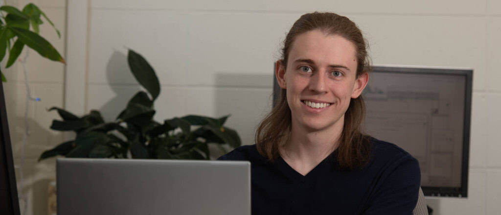 Photo of UW-Eau Claire senior Carl Fossum, who will graduate in May 2022 and is beginning his process of finding graduate programs where he will pursue a Ph.D. in computational chemistry. In addition to a career in research, Fossum hopes to teach at the college level. (Photo by Bill Hoepner)