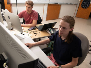 Photo of Carl Fossum (right), who presented in the WiSys Quick Pitch competition. The research team included up to nine other students at points in the project. Alex Narkiewicz-Jodko (left) played a key role in the study and publication. (Photo by Bill Hoepner)