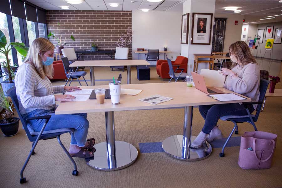 Photo of school psychology graduate students Remi Larson, left, and Liv Russo studying in Laurentide Hall on Wednesday, April 27, 2021. They participated with their cohort in online academic interventions to help students at Washington Elementary School with math and reading.