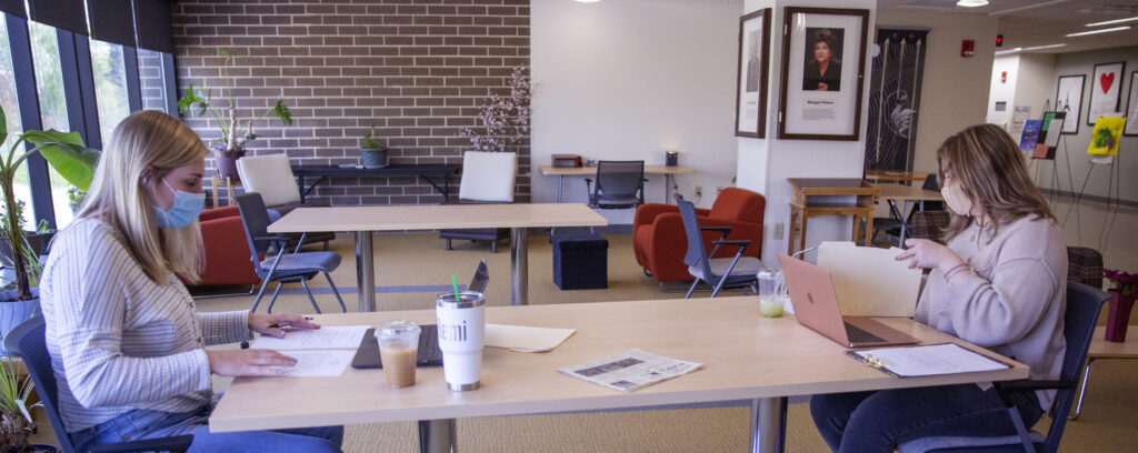 Photo of school psychology graduate students Remi Larson, left, and Liv Russo studying in Laurentide Hall on Wednesday, April 27, 2021. They participated with their cohort in online academic interventions to help students at Washington Elementary School with math and reading.