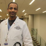 Photo of Dr. Woubeshet Ayenew, who was still in his medical residency when he found his calling, providing care to underserved populations in Minneapolis. Nearly 20 years later, he’s a respected cardiologist and community advocate in the Twin Cities, providing care while also trying to increase the number of African American physicians.