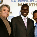 Photo of Dr. Sean Hartnett, UW-Eau Claire professor of geography, standing with marathoners Paul Tergat, center, and Haile Gebrselassie at a 2011 celebration of world record holders at the 2011 Berlin Marathon.