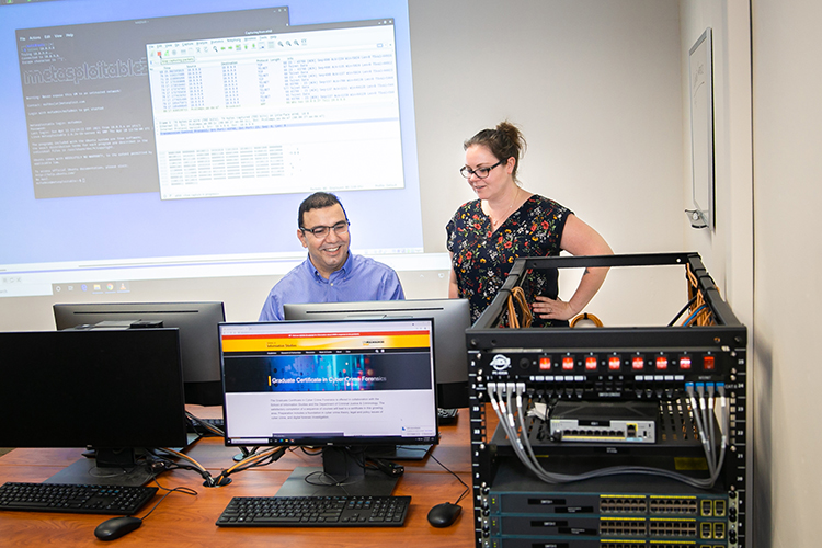 Photo of UW-Milwaukee faculty Khaled Sabha and Danielle Romain Dagenhardt, who are helping offer a new graduate certificate in cybercrime forensics, which includes classes in ethical hacking and computer forensics. (UWM Photo/Elora Hennessey)