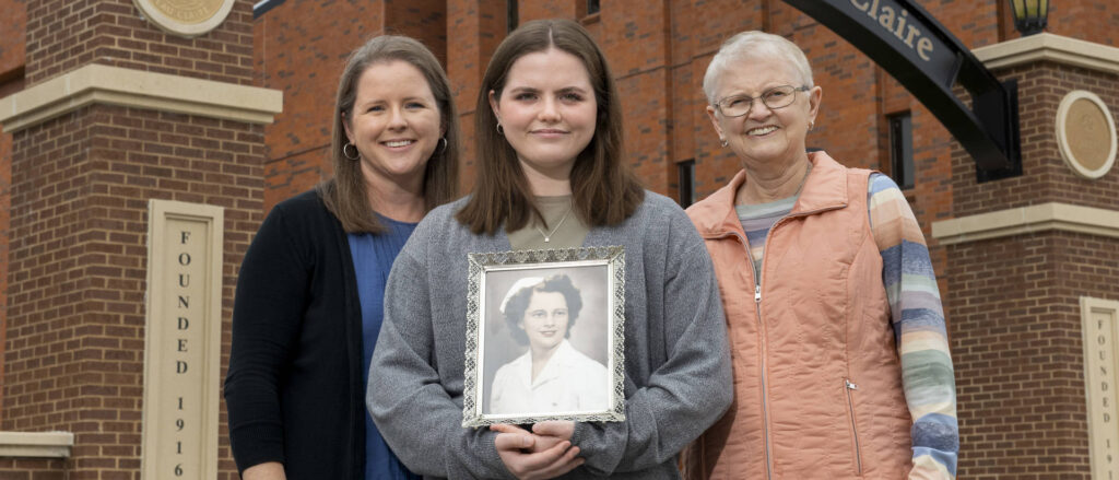 Photo of new UW-Eau Claire freshman Lucy Franklin (center), who is the fourth generation of Blugolds in her family. Her mother, Beth Franklin, (left) and grandmother, Christy Linderholm, (right) both are UW-Eau Claire graduates. Lucy is holding a photo of her great-grandmother, Ruby (Johnson) Hanson, who earned her nursing degree from the precursor to UW-Eau Claire’s nursing program, so also is considered a Blugold.