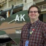 Photo of Sean Mobley, '12, a social media and content specialist for the Museum of Flight in Seattle. As a student at UW-La Crosse, Mobley recorded podcasts in his residence hall using a Guitar Hero microphone — experience that has come in handy throughout his career.