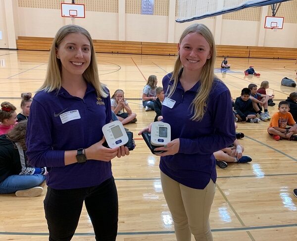 Photo of UW-Stevens Point health promotion and wellness students working with the Nekoosa School District on blood pressure screening, one of the partnerships that will be enhanced with a $3 million gift from the Legacy Foundation of Central Wisconsin.