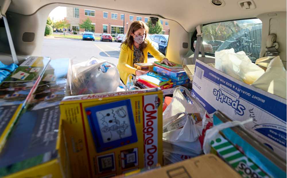 Photo of Lisa Klein, UW-La Crosse Community Engagement Coordinator, loading toys collected for Afghan children at Fort McCoy. The two-week, campus-wide effort netted around 400 toys.