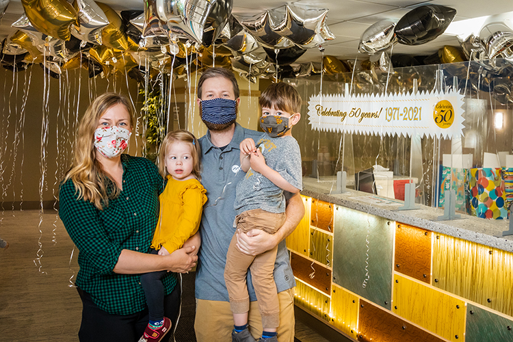 Photo of Ryan Rupp, who attended the Children’s Learning Center as a child and now, his children are there. Rupp is pictured at the 50th anniversary celebration with his wife, Brenda Hasse-Rupp, and their two children, Arthur and Margot. (UWM Photo/Elora Hennessey)