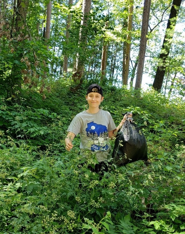 Photo of Asa Plonsky, Stevens Point, a 2018 graduate in biology and water resources, who works at Golden Sands coordinating two groups that manage invasive species. They also provide educational workshops and webinars to increase awareness of invasive species.