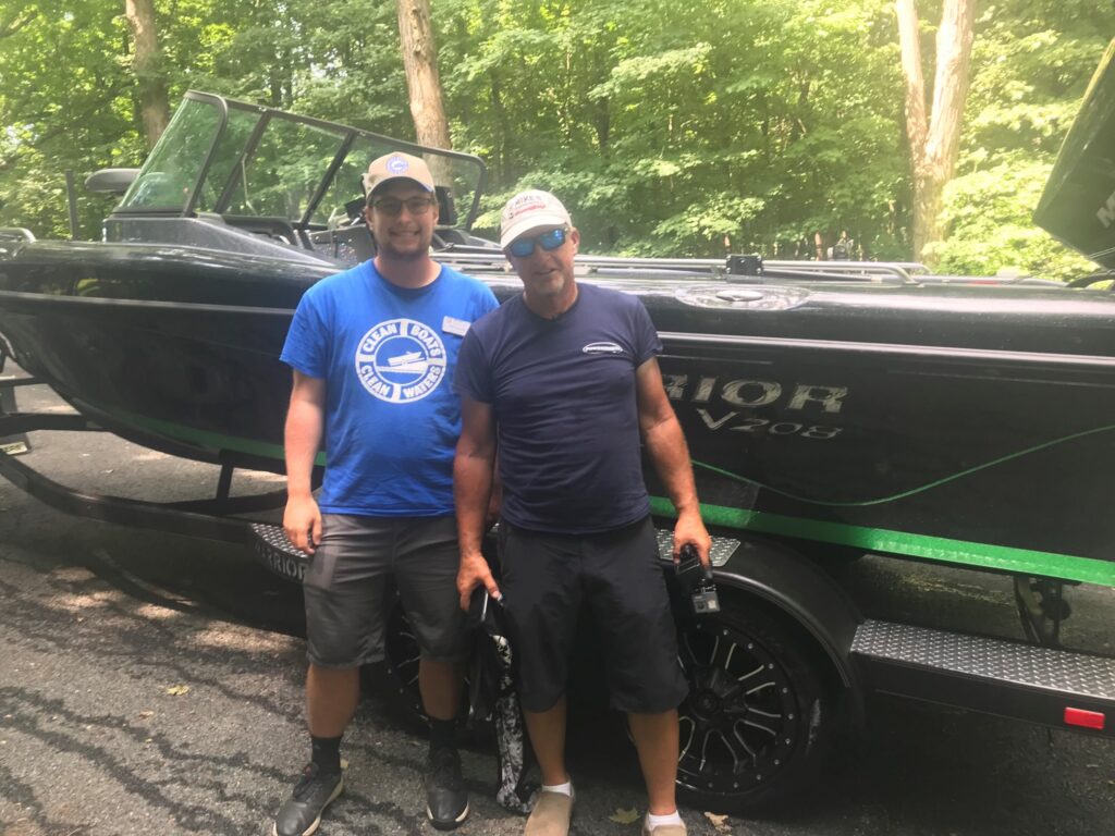 Photo of UW-Stevens Point student Phil Troschuk (left), who met the host of Larry Smith Outdoors while working as a Clean Boats Clean Waters agent on Green Lake. 