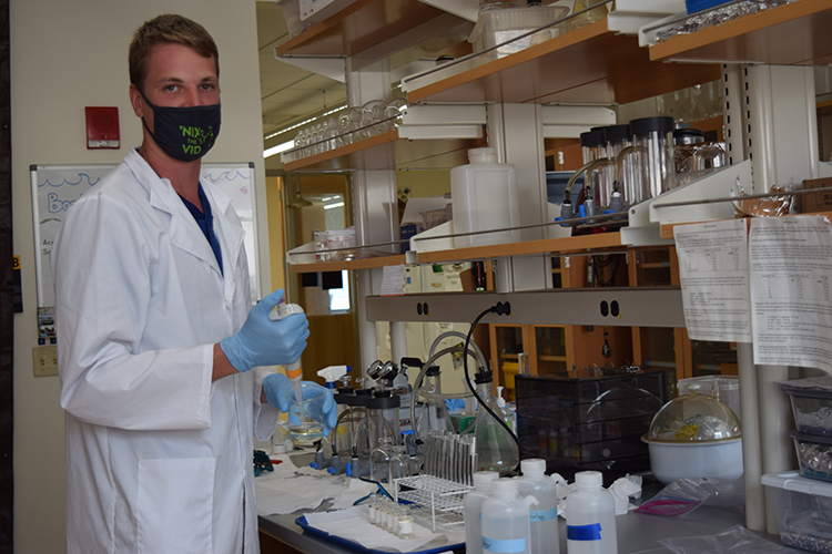 Photo of UW-Milwaukee School of Freshwater Sciences student Tyler Kunze, who developed an appreciation for the environment while growing up on a dairy farm outside of Green Bay. (UWM Photo/Heidi Jeter)