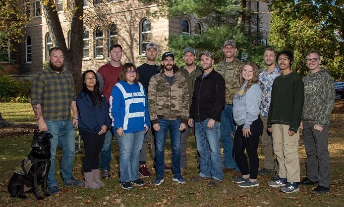 Photo of members of UWSP's Veterans Club in front of Old Main