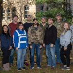 Photo of members of UWSP's Veterans Club in front of Old Main