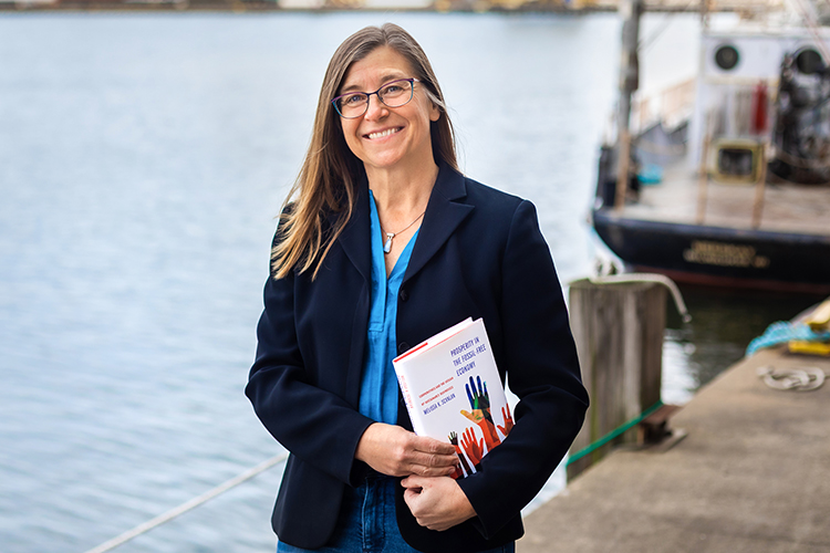 Photo of UW-Milwaukee professor Melissa Scanlan, who provides a blueprint for an alternate business model that incorporates green practices, pays living wages and preserves community jobs in her new book, “Prosperity in the Fossil-Free Economy.” (UWM Photo/Elora Hennessey)