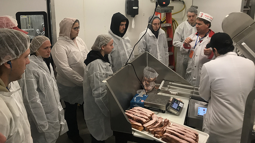 Photo of Jake Sailer of Sailer’s Food Market and Meat Processing in Elmwood discussing the balancing act between producing new and unique food products while maintaining a reliable supply of successfully branded products.