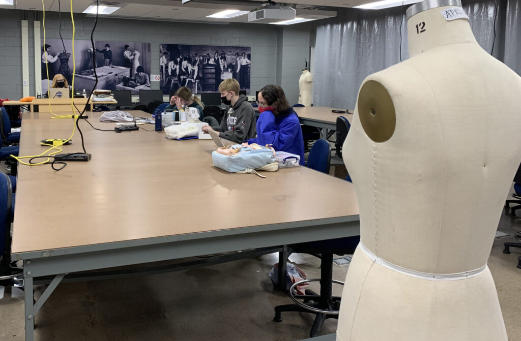 Photo of the Makers Laboratory and other renovated spaces, which include large work tables for collaborating on projects and large, historic lab photos on the walls.