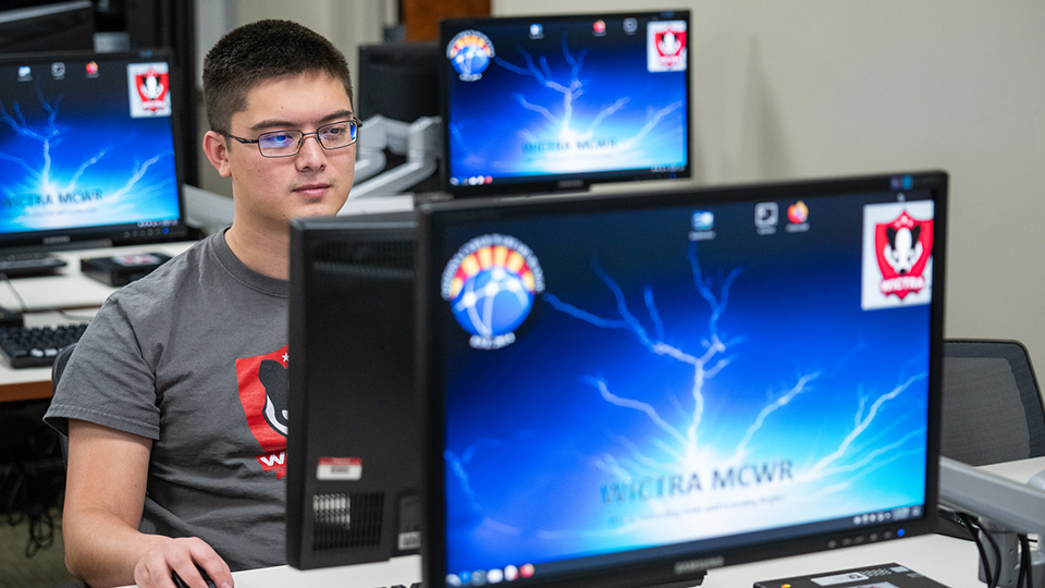 Photo of UW Oshkosh student working at computer
