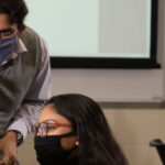 Photo of Dr. Rahul Gomes, assistant professor of computer science, talking with student researcher Avi Devy Mohan about their 2021 research, which was a collaborative project with Mayo Clinic Health System.