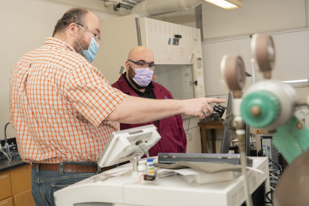 Photo of Dr. Kurt Wiegel (left) and Broc Kelley, who have worked together on synthetic organic chemistry research for more than a year. Kelley has earned a full scholarship to the UW School of Medicine and Public Health in Madison. (Photo by Shane Opatz)