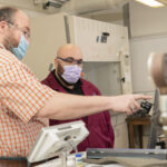 Photo of Dr. Kurt Wiegel (left) and Broc Kelley, who have worked together on synthetic organic chemistry research for more than a year. Kelley has earned a full scholarship to the UW School of Medicine and Public Health in Madison. (Photo by Shane Opatz)