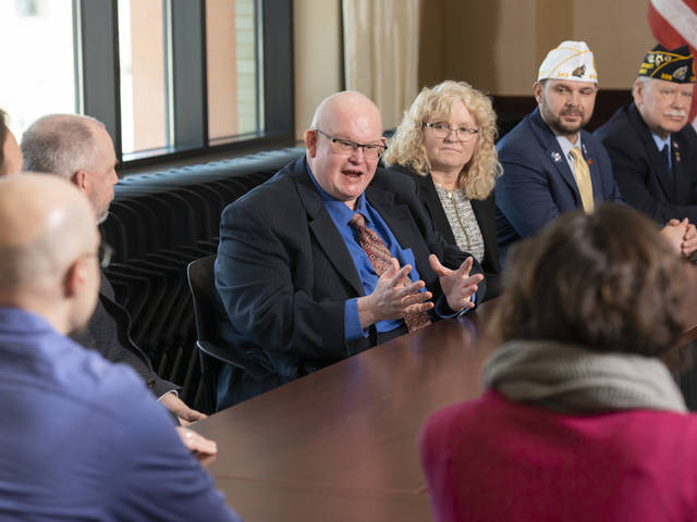 Photo of representatives of Badger Boys State and the American Legion of Wisconsin on campus for the signing (from left) Bill Cosh, Sheri Hicks, Nathan Gear and Robert Batty. (Photo by Shane Opatz)