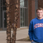 Photo of Blugold Ethan Van Grunsven, who brought his love for business and his home state of Wisconsin together to launch the apparel company Sconny Co. The business student creates and sells apparel for people who are proud to be from Wisconsin. (Photo by Bill Hoepner)