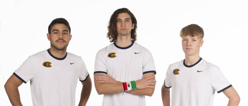 Photo of three members of UW-Eau Claire’s tennis team, who are international students, coming to the university from three different countries. Victor Simoes (left) is from Brazil, Jose Felipe Trejo (middle) is from Mexico, and Otto Schluter (right) is from England. All three say UW-Eau Claire’s reputation for quality athletics and its legacy tennis program brought them to campus. (Photo by Bill Hoepner)