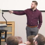 Photo of Prof. Aaron Weinschenk leading a classroom discussion