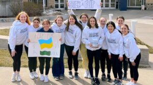 Photo of members of UW-Stout’s gymnastics team promoting their #stuckflipforabuck fundraiser for the people of Ukraine. The challenge started at UW-Stout and has spread nationally. / Kailyn Westbrook