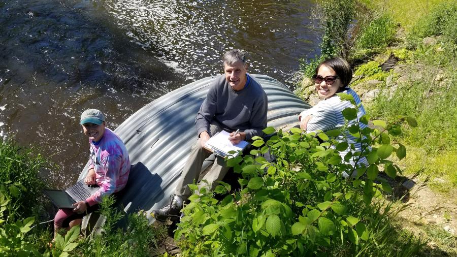 Photo of (from left) intern Heidi Lieffort, CLRR Director Bill James and CLRR Manager Mai Lia Vang sampling water from Horse Creek, which flows into Cedar Lake in Polk County. / UW-Stout