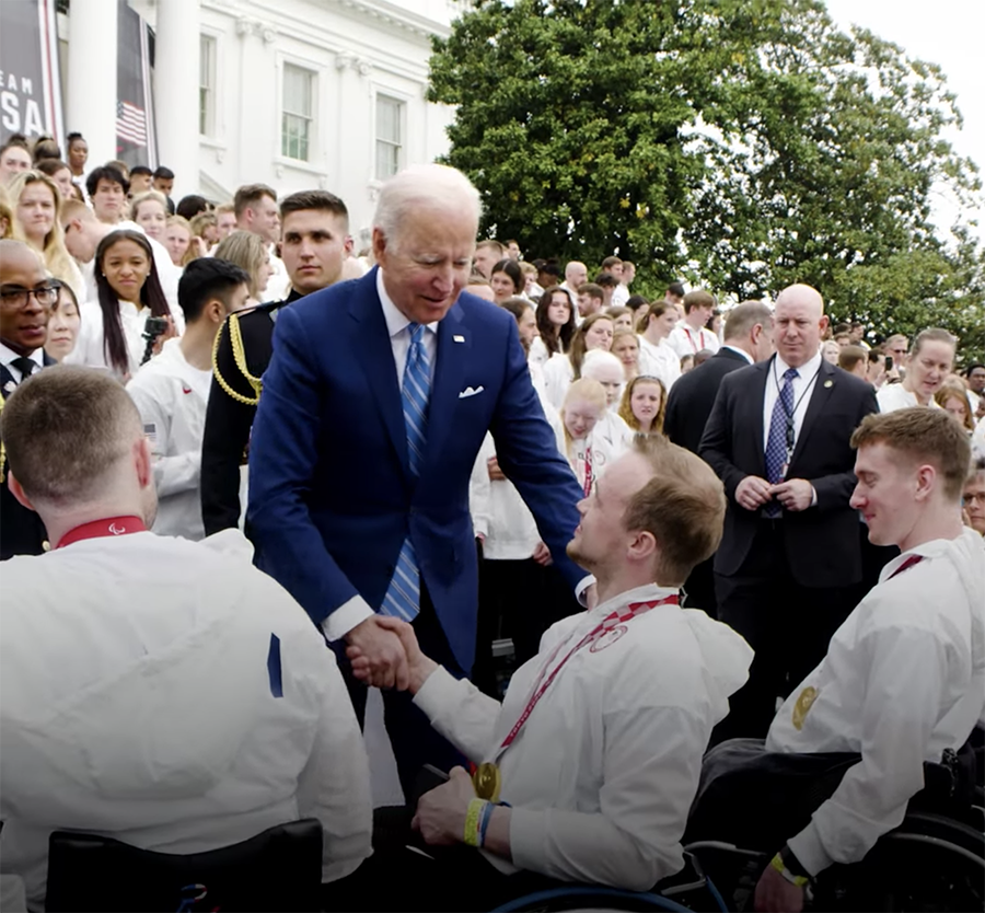 Photo of President Joe Biden, standing, shaking John Boie’s hand at a special ceremony at the Whitewater. (Photo courtesy of the White House)