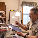 Photo of UW-Superior Professor Michael Waxman tutoring a group of Ukrainian students.