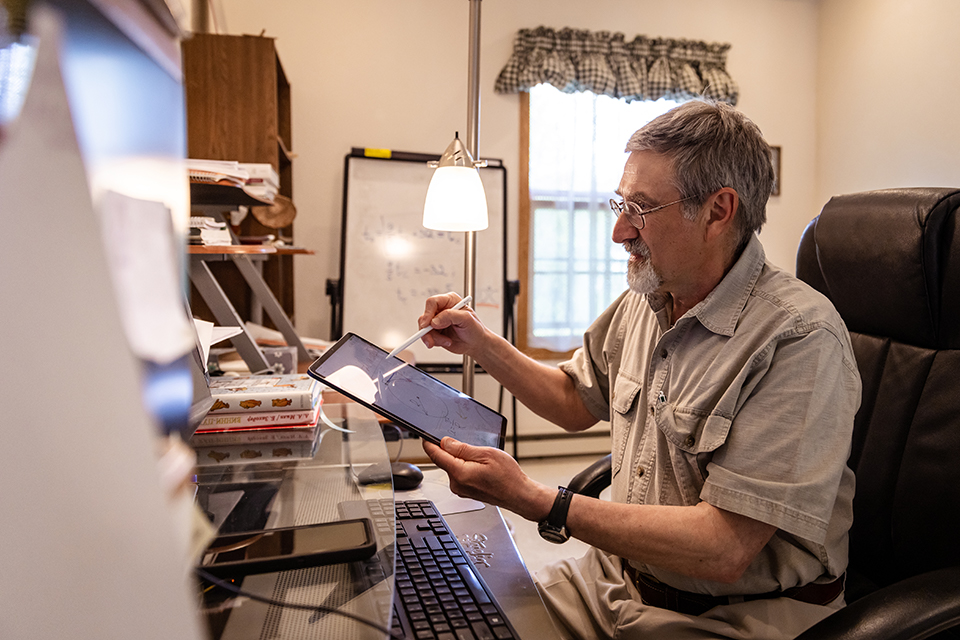 Photo of UW-Superior Professor Michael Waxman tutoring a group of Ukrainian students.