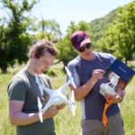 Photo of UWL student Travis Key (left) and UWL Professor Colin Belby preparing to fly a drone over a two-mile stretch of Plum Creek in rural Crawford County. The team is using drone imagery, soil samples and geographic information to help the Mississippi Valley Conservancy restore the area to its natural state.