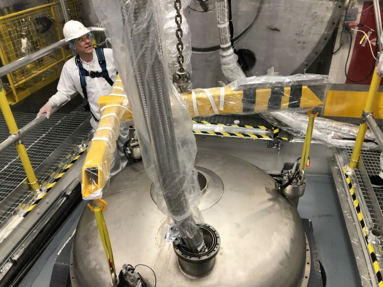 Photo of Jeff Cherwinka of the UW–Madison Physical Sciences Lab coordinating the xenon cryostat head installation. PHOTO BY DEREK LUCERO