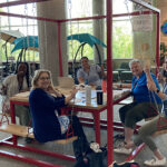 Photo of members of the first class of UWRF doctoral candidates in Montessori studies meet to work on a class project at the University Center.