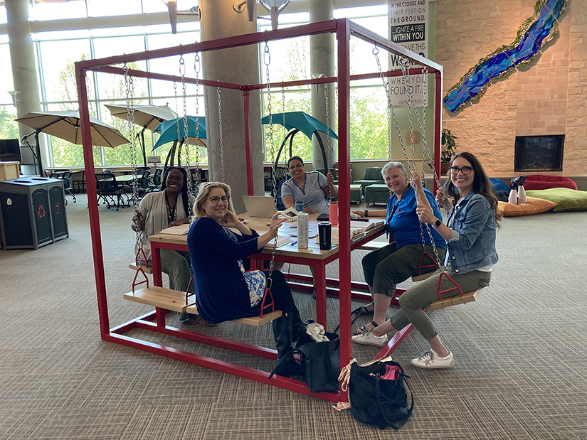 Photo of members of the first class of UWRF doctoral candidates in Montessori studies meet to work on a class project at the University Center.