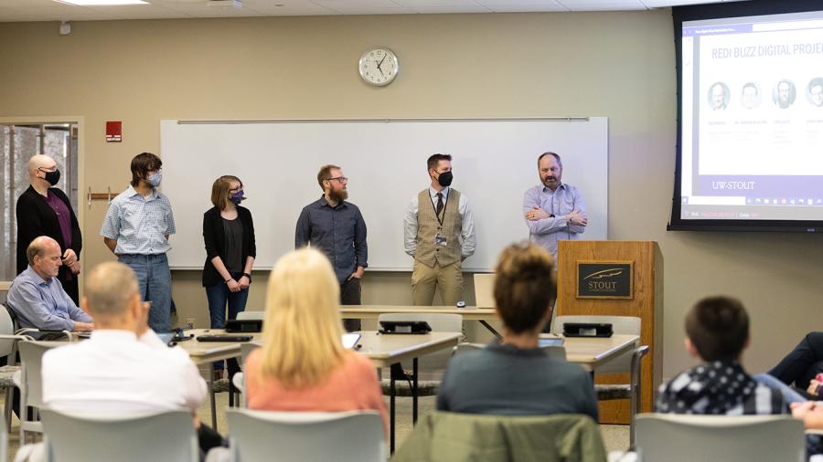 Photo of students, to the left of Ted Theyerl and Andrew Williams, who were hired to develop Buzz Digital, with guidance from faculty and staff and through a national grant. / UW-Stout