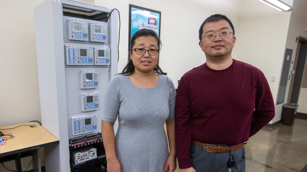 Photo of Dr. Yanwei Wu and Dr. Xiaoguang Ma (pictured left to right), along with Dr. Fang Yang, who will research and build a prototype of a smart microgrid testbed.