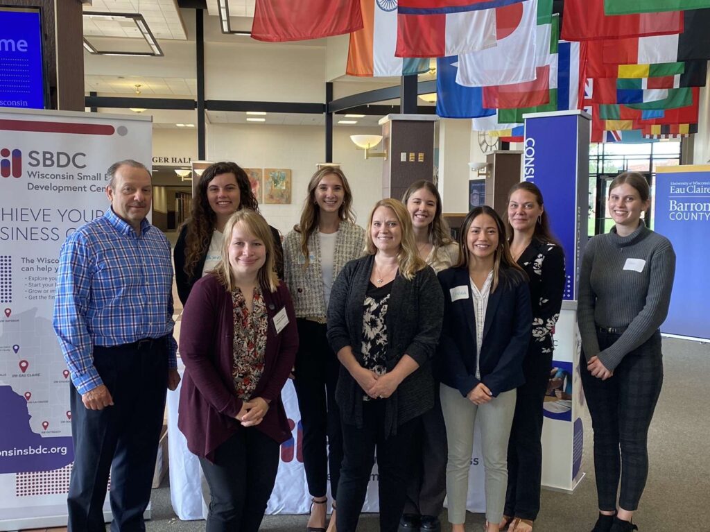 Photo of staff members of the Wisconsin Small Business Development Center at UW-Eau Claire and student consultants who took part in a pop-up small business clinic. Back, from left, Luke Kempen, SBDC outreach program director; student consultants Allison Kind, Lauren Prellwitz and Brooke Wobschall; Robin Rundquist, SBDC financial consultant; and student consultant Emma Gilkerson. Front, from left, Harlie Juedes, SBDC outreach program director; Beth Kayhart, owner of On Track Bookkeeping; and student consultant Linnea Vesely.