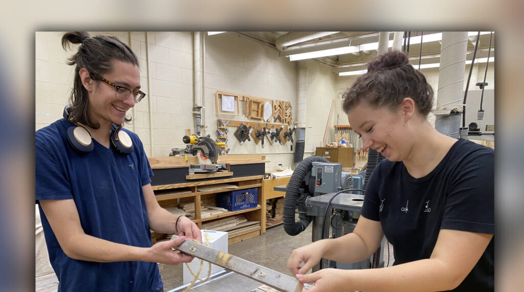 Photo of Jacob Hallett (left) and Megan Miller, pictured in the Haas woodshop repurposing wood from a previous campus installation, worked on "Expressions of Nature" throughout the summer of 2022. (Submitted photo)