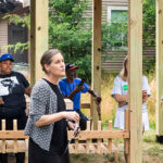 Photo of Mo Zell, interim dean of UWM's School of Architecture and Urban Planning, talking to students, their families and community members during a ribbon-cutting ceremony. (UWM Photo/Elora Hennessey)