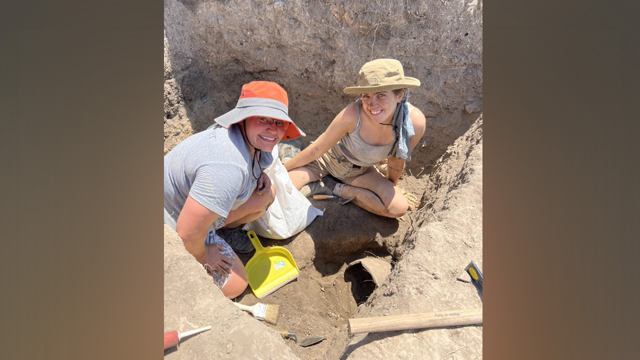 Photo of Becca Bartusewich (left), advising manager for the Office of Professional Program Support, participating in an archaeological dig.
