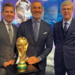Photo of (from left) broadcasters Angus Scott, Ruud Gullit, a former Chelsea and Dutch national team player, and Arsène Wenger, former Arsenal manager, appearing on set at the Qatar World Cup with the Jules Rimet Trophy.