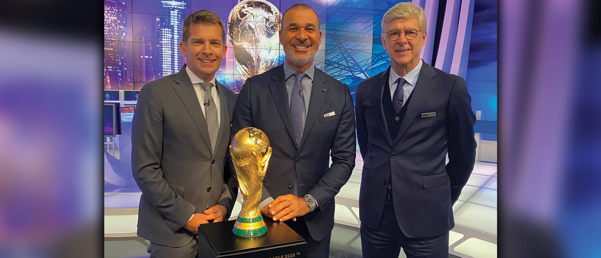 Photo of (from left) broadcasters Angus Scott, Ruud Gullit, a former Chelsea and Dutch national team player, and Arsène Wenger, former Arsenal manager, appearing on set at the Qatar World Cup with the Jules Rimet Trophy.