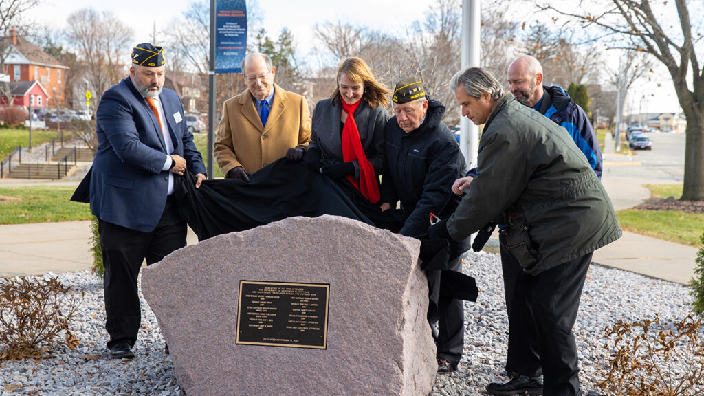 Photo of the unveiling of the Vietnam Veterans Memorial at UW-Platteville. (from left to right) Greg Tremelling, Coordinator of UW-Platteville’s Wright Center for Non-Traditional and Veteran Students; Dr. James Lawton; Interim Chancellor Tammy Evetovich; Lt. Col. Mac Kolar; Interim Provost Wayne Weber; and Professor of History Dr. David Krugler. (Photo credit: UW-Platteville)