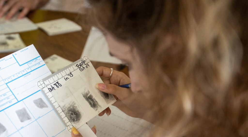 Photo of a student in UW-Platteville's Criminal Justice and Forensic Investigation programs examining evidence. (Photo credit: UW-Platteville)