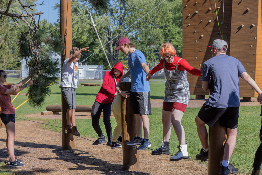 Photo of Stoutward Bound participants trying the campus ropes course in August. / UW-Stout
