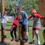 Photo of Stoutward Bound participants trying the campus ropes course in August. / UW-Stout